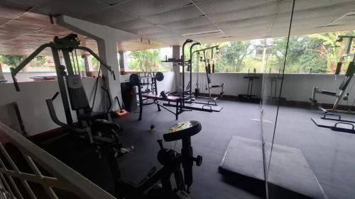 a gym with several treadmills and machines in it at Ecohotel Santa Barbara in Circasia