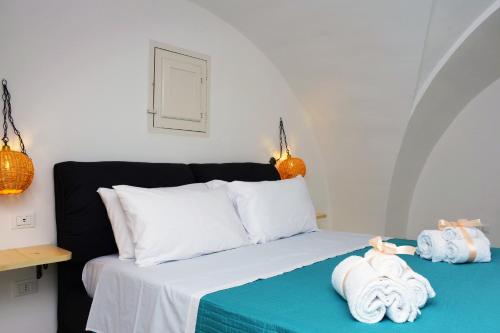 a bedroom with a bed with towels on it at Miria B&B in Castrignano del Capo