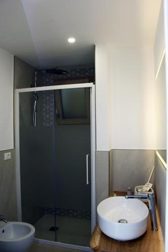 a bathroom with a glass shower and a sink at Miria B&B in Castrignano del Capo