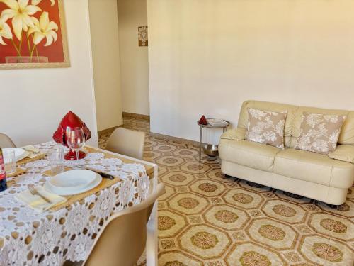 a living room with a table and a couch at Mantula Home By JDvacanze in Manduria