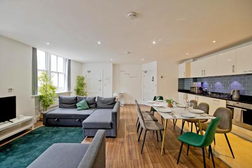 a living room with a couch and a table at Imperial liverpool street apartments in London