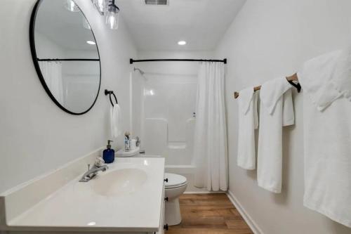 a white bathroom with a sink and a mirror at Rough River Multi Family Charmer in McDaniels