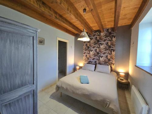 a bedroom with a bed with a wall mural at Gîte Authentique Calme avec Piscine et Jardin Privé - FR-1-616-474 in Sainte-Sabine