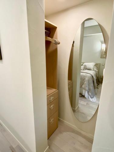 a bedroom with a large mirror and a bed at Le Boudoir de Syssi in Saint-Rabier
