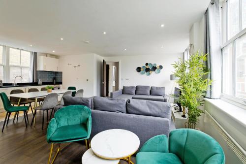 a living room with a couch and a table and chairs at Imperial liverpool street apartments in London