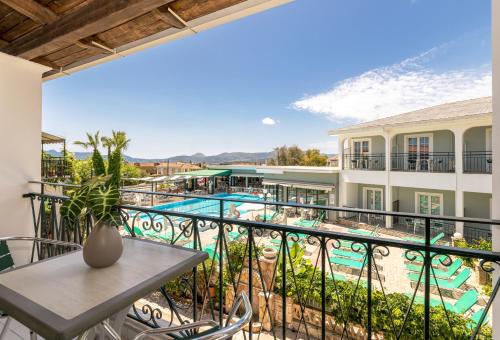a view of the pool from the balcony of a resort at Sofia's Hotel in Kalamaki