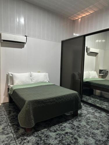 a bedroom with a bed and a large mirror at Casa Buen Agüero in San Antonio