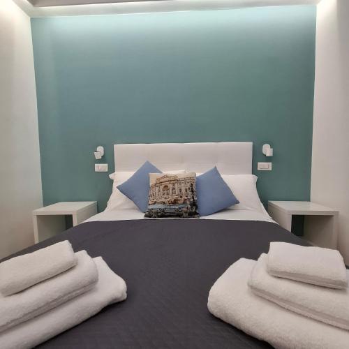 a bedroom with a bed with towels on it at Bemy in Rome