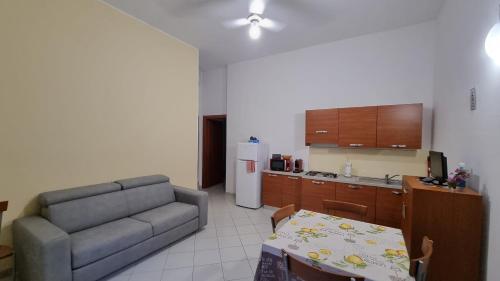 a living room with a couch and a kitchen at La casa di Follonica in Follonica