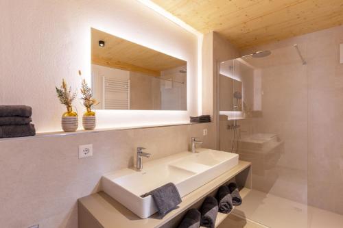 a bathroom with a sink and a mirror at Apartments Bären in Elzach