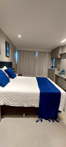 a large bedroom with a large bed with blue sheets at ArtStudio Open Spaces in Salvador