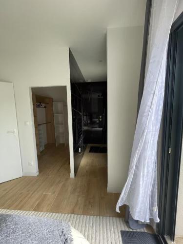 a bedroom with a bed and a hallway with a mirror at Maison moderne avec Piscine in Creysse