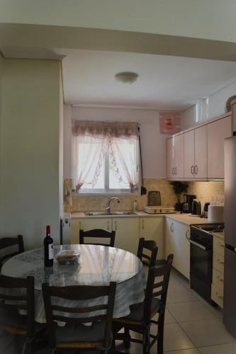 a kitchen with a table with a bottle of wine on it at Calma House in Kanálion