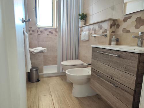 a bathroom with a toilet and a sink at Michela's house in Capo Vaticano