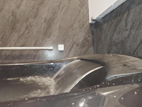 a metal toilet in a bathroom with a sink at Somnus豊田 ペットOK 最大宿泊人数12名!1棟貸切の宿 in Toyota