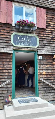 a couple of people standing in the doorway of a store at Bergchalet mit Pool und Sauna in Missen-Wilhams
