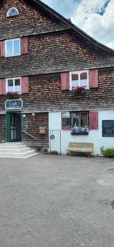 a brick building with a bench in front of it at Bergchalet mit Pool und Sauna in Missen-Wilhams