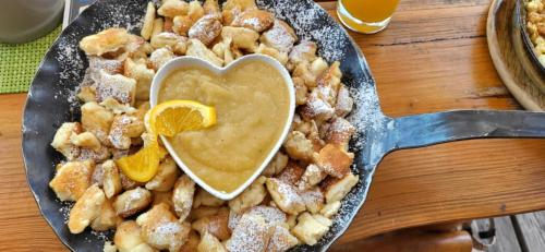 a plate of food with a heart shaped dessert at Bergchalet mit Pool und Sauna in Missen-Wilhams