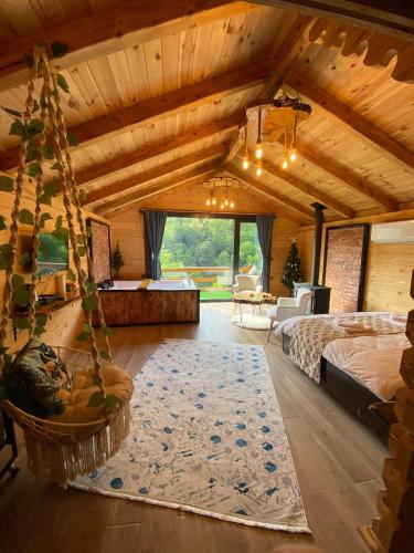 a large room with a bed and a living room at Maysa Suit Bungalov in Çamlıhemşin