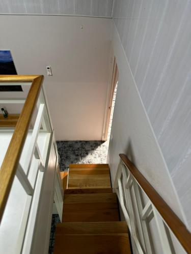 a staircase in a house with white walls and wooden floors at Casa Buen Agüero in San Antonio