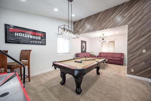 a living room with a pool table and a couch at Poolside Paradise on the Strip in Las Vegas