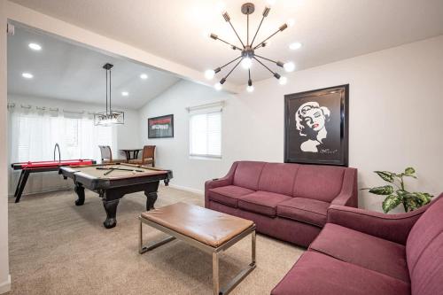 a living room with a couch and a pool table at Poolside Paradise on the Strip in Las Vegas