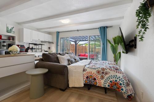 a small bedroom with a bed and a kitchen at 100% Private, KingBed- SouthCoast/Newport/Disney in Costa Mesa