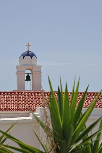 a bell tower on top of a roof at Athos Studios in Tinos Town