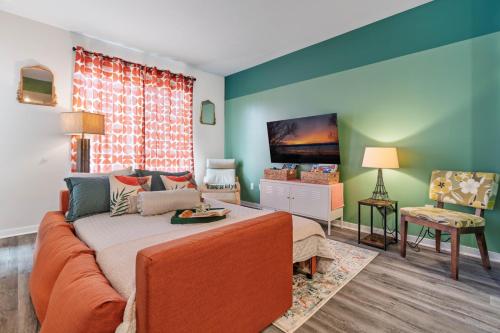 a living room with a couch and a flat screen tv at Le Nid Trailside 1BD Close to Beach Downtown in Traverse City