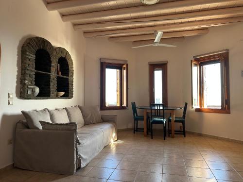 a living room with a couch and a table at Andros Escape Condos in Andros