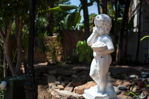 a statue of a little boy holding a shell at Summerview Guest Lodge in Johannesburg