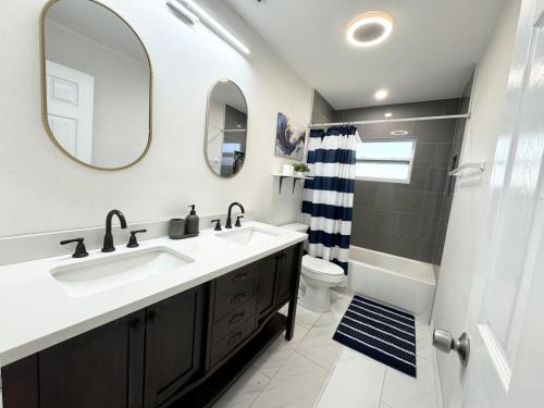 a bathroom with a sink and a toilet and a mirror at Home close to Clearwater beach in Largo