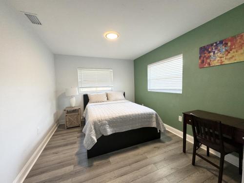 a bedroom with a bed and green walls at Home close to Clearwater beach in Largo