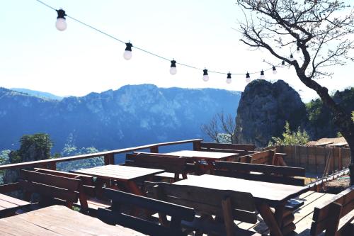 a picnic table on a deck with mountains in the background at Kanjon 987 in Podgrad