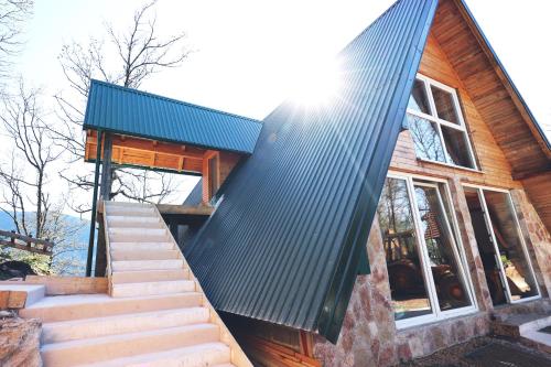 a house with a green roof and stairs at Kanjon 987 in Podgrad