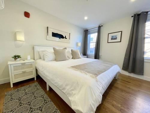 a bedroom with a large white bed and a window at 4 King Suites, Downtown, Outlets, Beach, Historic in Portsmouth