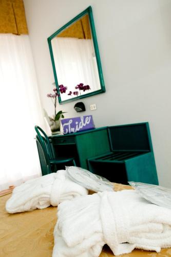 a bedroom with two white towels on a bed at Hotel Iride & Spa bed&breakfast in Cesenatico