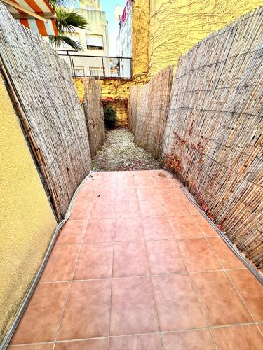 a brick walkway leading into an alley with a building at MT Boutique Suites y Apartamentos - Adults Only - in Mataró