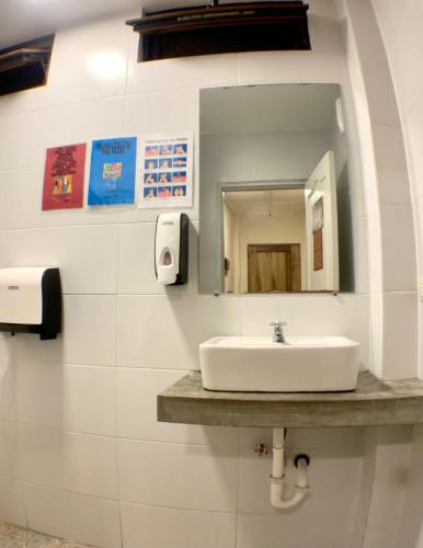 a bathroom with a sink and a mirror at Hotel Montañita in Montañita