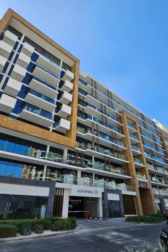 a large apartment building with a parking lot at Relaxing Retreat in Meydan in Dubai