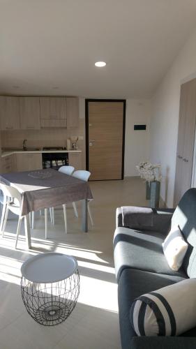 a living room with a couch and a table at Mare Apartment 4 in Scalea
