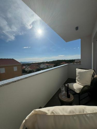 a balcony with a bed and a table with a view at Apartment Mimi in Zadar