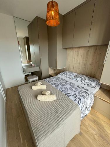 a bedroom with a bed with two towels on it at Apartment Mimi in Zadar