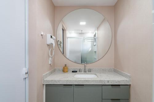 a bathroom with a sink and a mirror at 360 Soma Perdizes in Sao Paulo