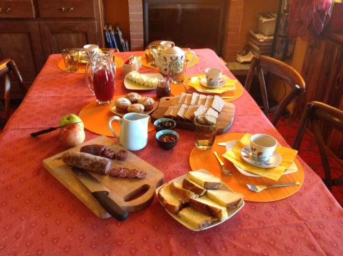 une table avec un tissu de table rouge et de la nourriture dans l'établissement Cascina Brunod, à Chiaverano