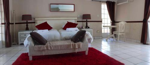 a bedroom with a bed and a red rug at Summerview Guest Lodge in Johannesburg