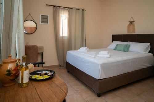 a bedroom with a bed and a table with a plate of food at TheaHouse in Pythagoreio