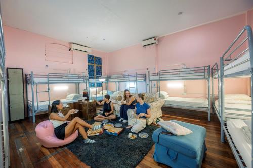a group of people sitting in a room with bunk beds at The Manor by Mingle - FREE Breakfast with Poolside Access in Kuala Lumpur