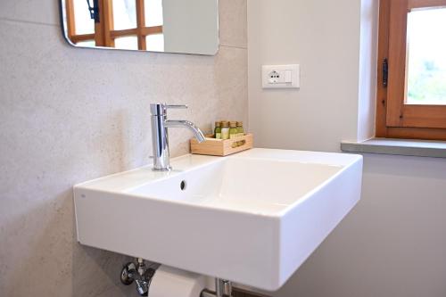 a white sink in a bathroom with a mirror at Villa Lucilla - B&B Rooms and Pool in Potenza Picena