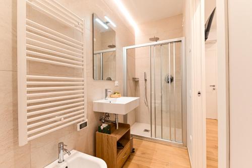 a white bathroom with a sink and a shower at Villa Lucilla - B&B Rooms and Pool in Potenza Picena